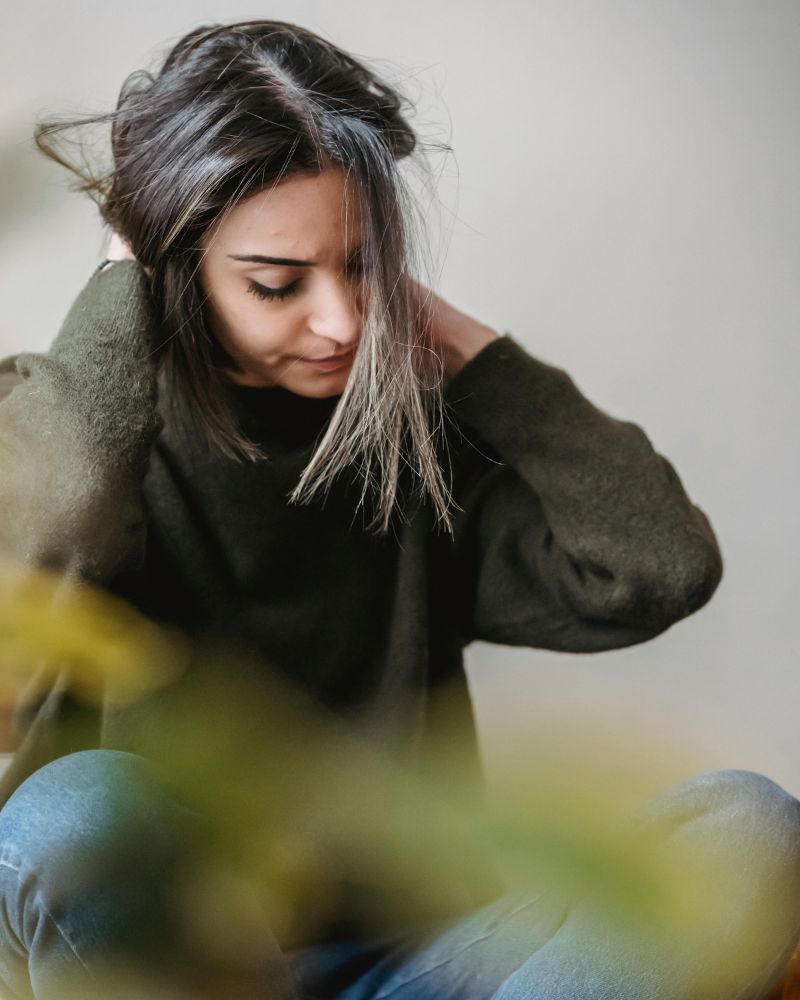 grieving woman fidgeting with her hair